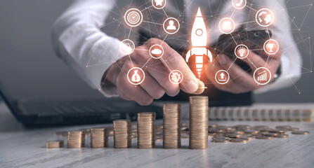 Man stacking coins and rocket. Concept of Growth. Investment. Success
