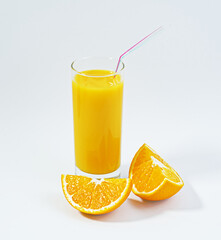 Close-up a glass of delicious and nutritious orange juice with a straw, oranges cut, white background