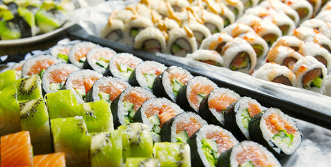 Various sushi, kiwi, salmon, fish roe, cucumber, crab sticks. Depth of field © Wheat field