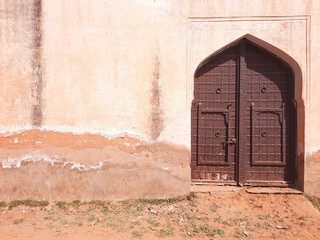 old vintage wooden door in historical fort with copy space on wall
