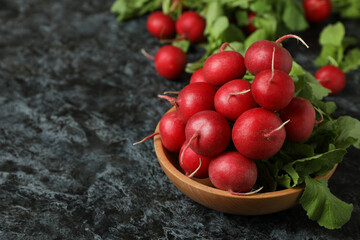 Bowl with fresh radish on black smokey table