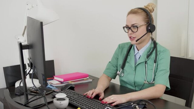 Medical practitioner using computer during online meeting