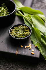 Fresh homemade wild garlic pesto. Home made sauce made with wild garlic, pine nuts, cheese and olive oil.
