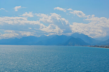 blue sky with clouds with mountains with sea 