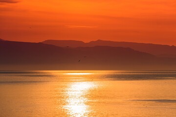 Beautiful sunrise by the sea, hazy morning, Golden water 