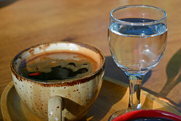 a cup of Turkish coffee with glass of water