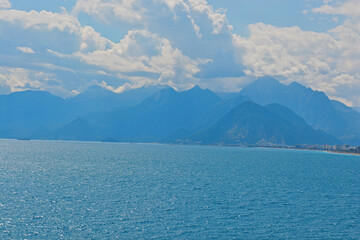 blue sky with clouds with mountains with sea 
