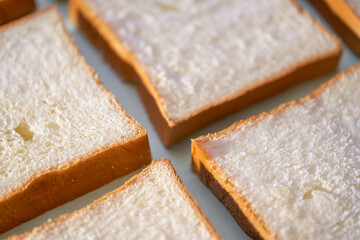 The slices of toast bread filling the picture are spread out on the table