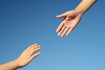Close-up of hands drawn to each other on blue background, friendship, help