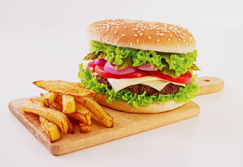 Close-up beef hamburger and french fries on wooden cutting board, white background, fast food takeaway