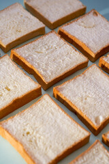 The slices of toast bread filling the picture are spread out on the table