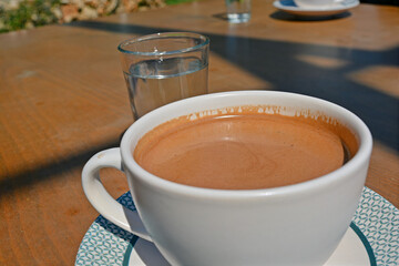 cup of Turkish coffee with glass of water