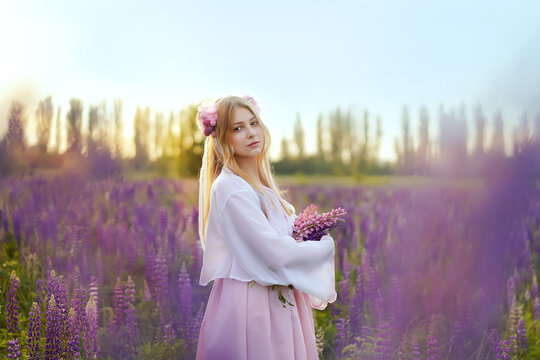 Beautiful blonde girl in a fantasy outfit dress on a field of lupines flowers at sunset in backlight.girl spring hello summer. Magical Photos, Korean Style Clothes.              