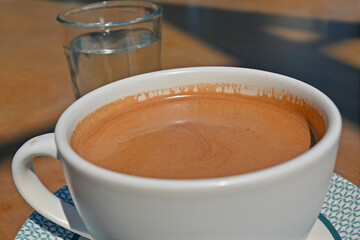 cup of Turkish coffee with glass of water