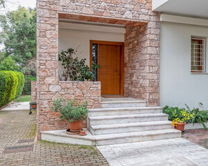 elegant house front marble stairs and natural wood door, Athens Greece