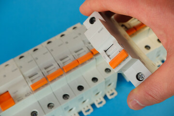 Automatic differential current switch and circuit breakers on a blue background.. Electrical engineering concept.