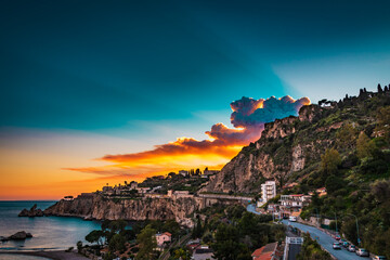 Incredible sunset sky over Isola Bella, Taormina, Sicily 