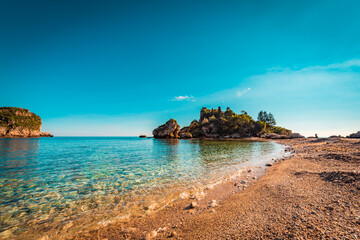 Low angle view of the beautiful beach in Taormina - Isola Bella - a famous tourist destination in Sicily 