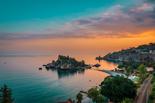 Beautiful sunset scenery over the small island of Isola Bella in Taormina, Sicily.  Teal and orange theme 