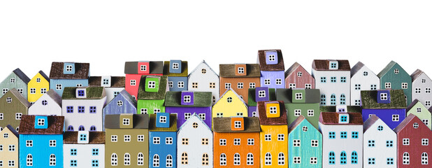 Row of wooden miniature colorful houses on white background