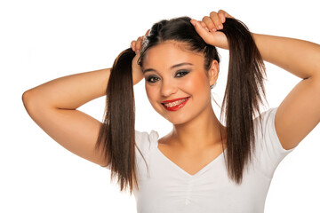 young funny woman holding her hair in two ponytails