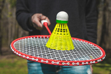 A woman with a racket plays badminton