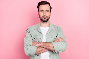 Portrait of attractive serious virile content guy folded arms isolated over pink pastel color background
