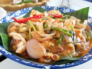 Thai food, spicy squid salad and salted egg.