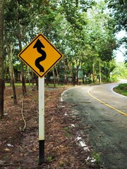 Traffic signs with yellow background and black arrows.