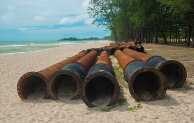 A rusty oil pipeline on the beach
