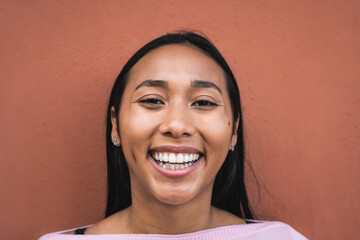 Portrait of happy young Latin hispanic woman smiling in front of camera