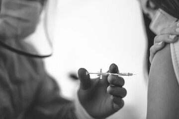 Medical worker doing vaccine injection to female patient for preventing and stop corona virus outbreak - Healthcare medicine and cure against covid19 disease concept