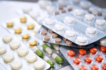 Overall view of pharmaceutical tablets and capsules in packages in assortment