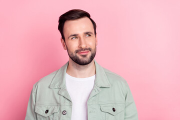 Fototapeta premium Photo of nice optimistic brunet man look empty space wear grey shirt isolated on pastel pink color background
