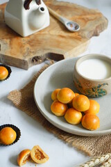 a plate of pineapple tart served with fresh milk on the table