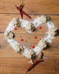 Khinkali in shape of a heart on a wooden table. Valentines Day concept, love for food.