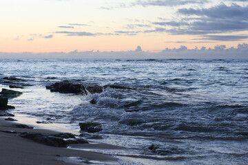Waves crashing against rocks in the North Shore of Oahu, Hawaii. 