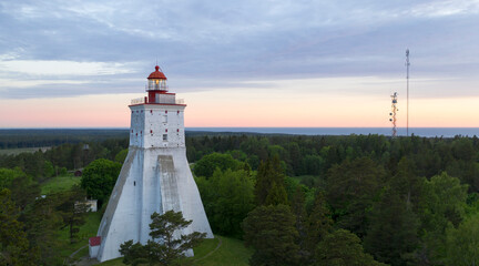Scenic aerial view to the historic Kõpu lighthouse in Hiiumaa isl, Estonia on the background the sunrise colored sky and sea