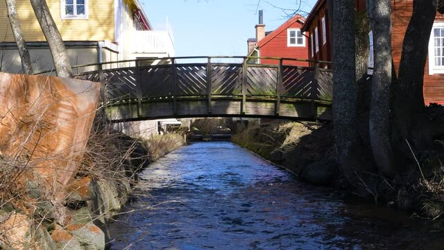 A small bridge over a creek in the town of Eksj&ouml;, Sweden, wide shot