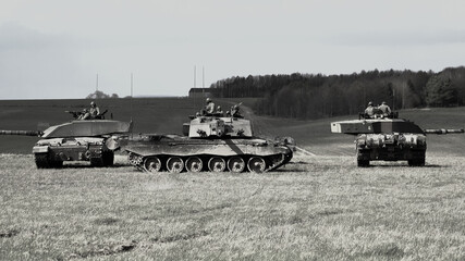 Fototapeta premium Four British Army Challenger 2 main battle tanks in a defensive square on a military exercise Wiltshire UK