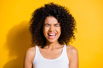 Photo of funny laughing young dark skin lady wear white singlet closed eyes isolated yellow color background