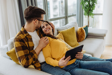 Girl holding tablet, while looking at her man.