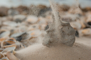 multicolored river pebbles stones randomly lie on the sand next to the sea. Macro photography. Close-up background concept, copy space