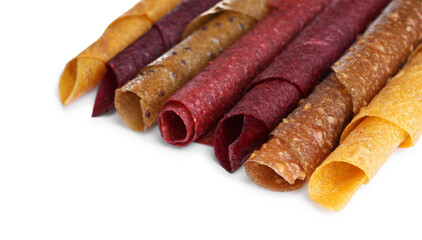 Delicious fruit leather rolls on white background