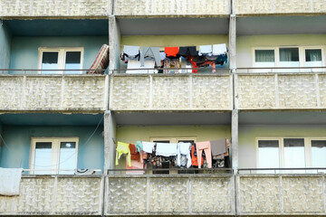 Balconies of a panel building in the ghetto with clothes hanging on ropes and drying. Third World...