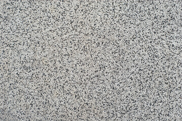 The texture of the wall is made of small black and white stones.
