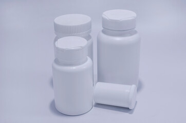 White plastic medical containers for pills and capsules