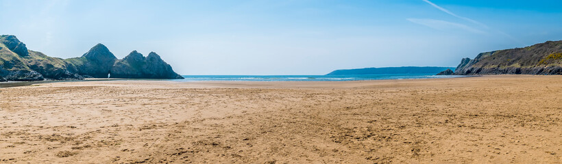 A panorama view across Three Cliffs Bay, Gower Peninsula, Swansea, South Wales on a sunny day