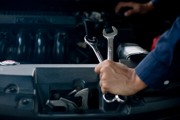 Car service, repair, maintenance concept. Auto mechanic working in garage.