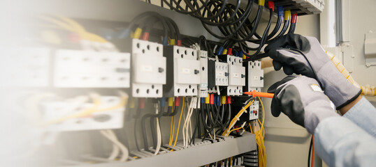Electrical engineers test electrical installations and wiring on protective relays, measuring them...